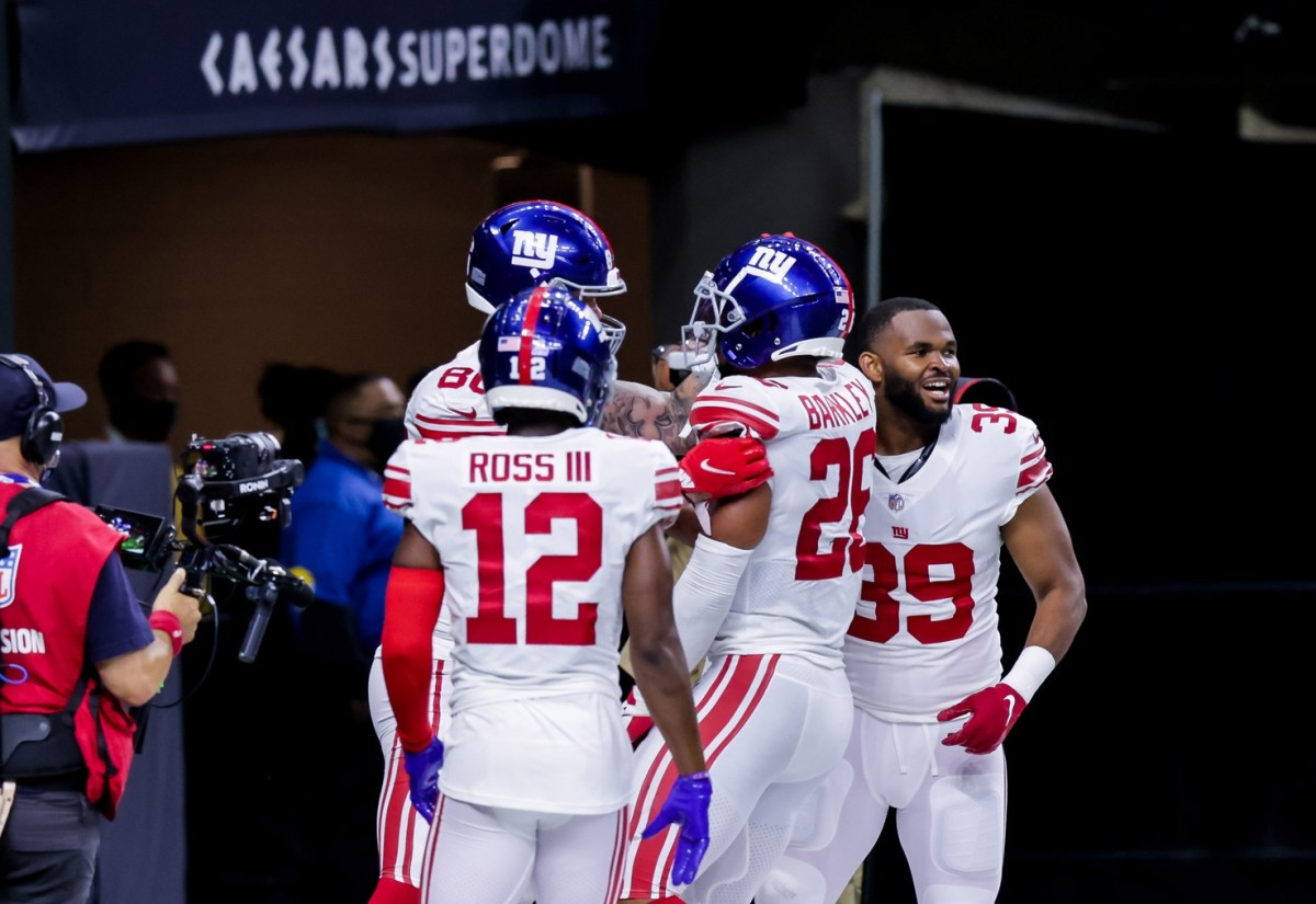 Oct 3, 2021; New Orleans, Louisiana, USA; New York Giants running back Saquon Barkley (26) reacts to scoring the winning touchdown against the New Orleans Saints in overtime at Caesars Superdome.